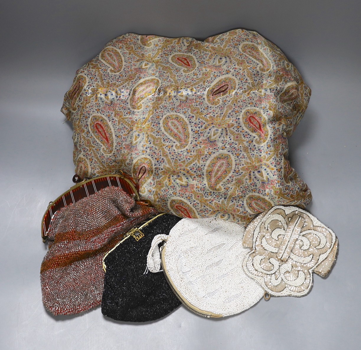 A paisley pattern silk shawl (damaged), together with four beaded evening bags